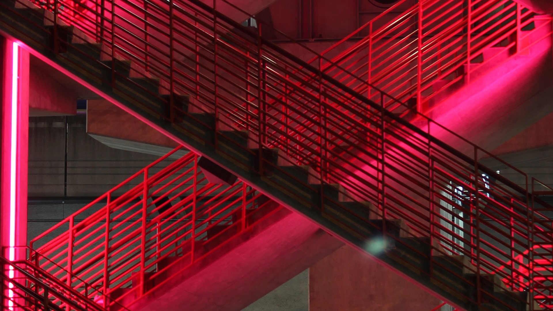Two staircases illuminated in red colour.