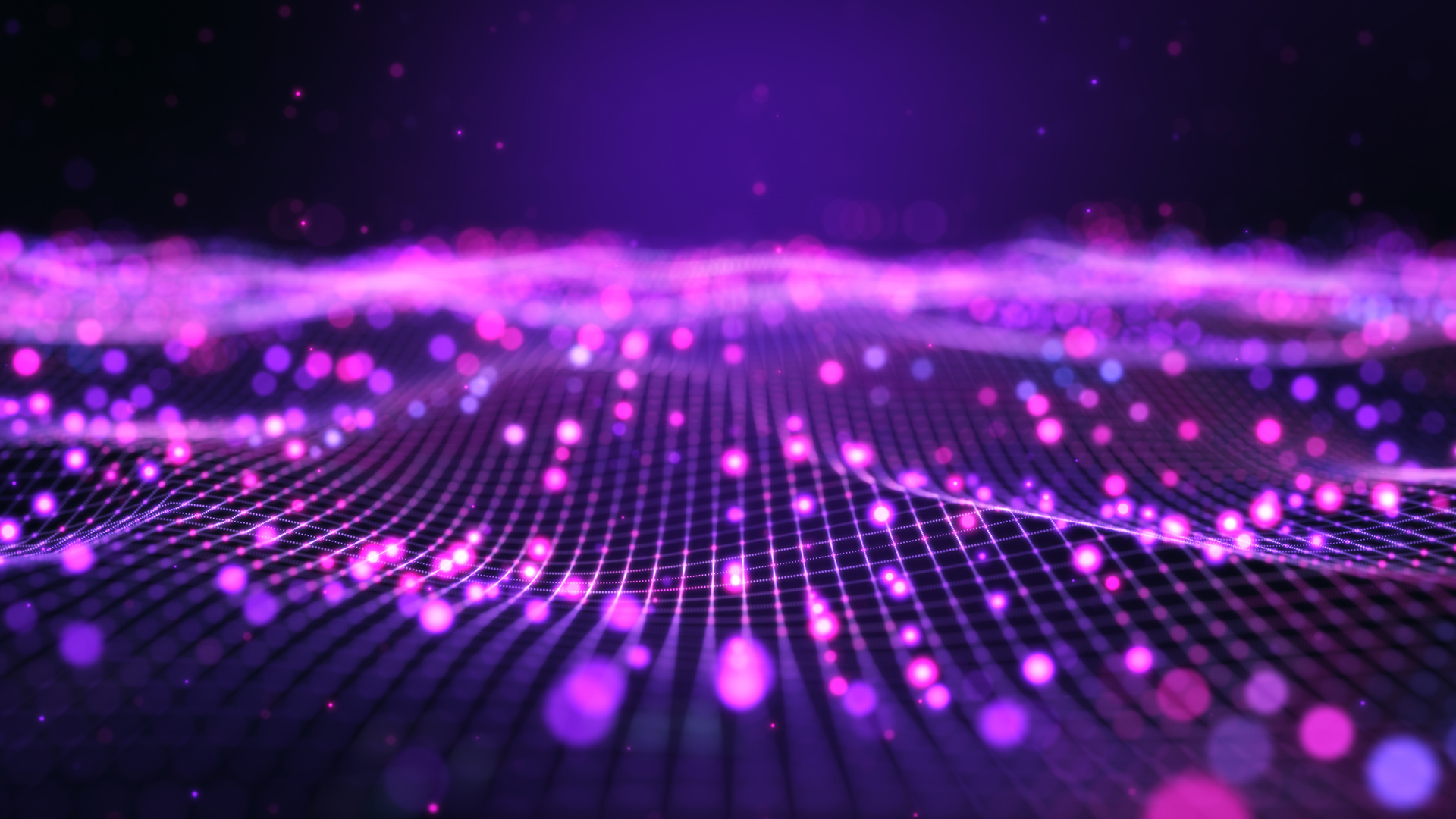 Purple microchip up-close with purple light reflecting off of it